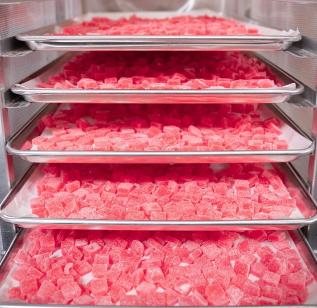 Delta munchies gummies in 5 trays placed on shelfs